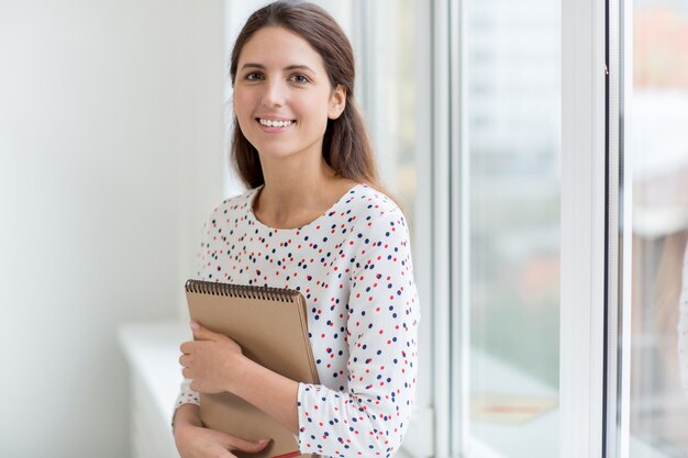 Girl smiling with notepad