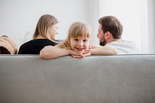 Girl on sofa near parents