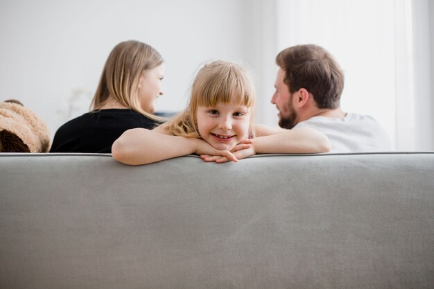 Girl on sofa near parents