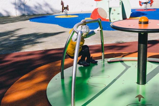 Free photo girl spinning on carousel