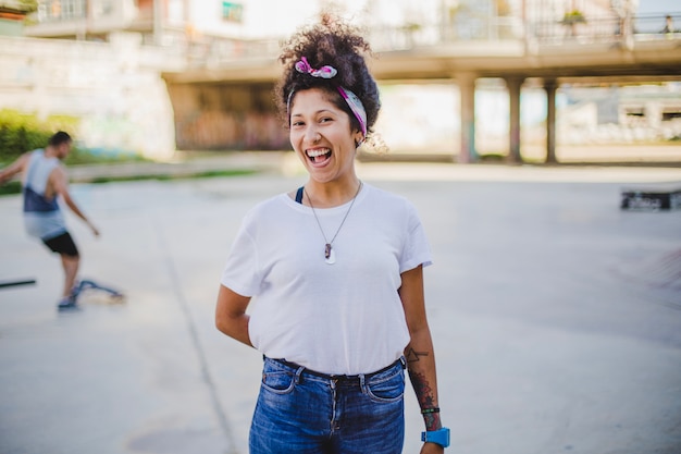 Girl standing outside holding hand behind back