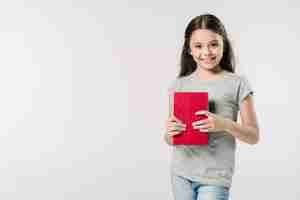 Free photo girl standing in studio with book