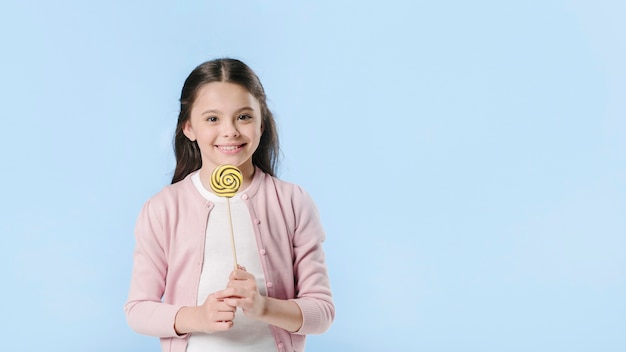 Girl standing in studio with candy