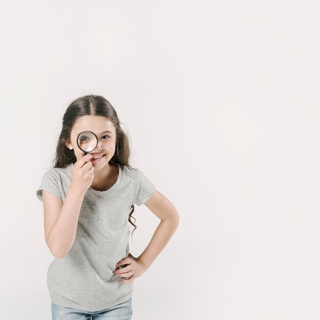 Girl standing in studio with loupe