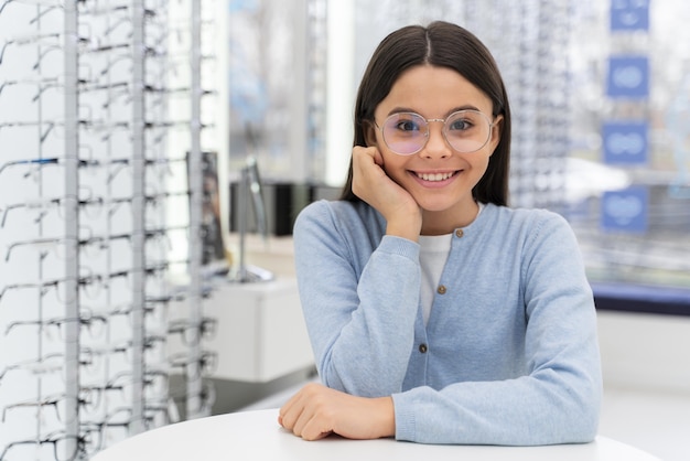 Girl in store trying on glasses