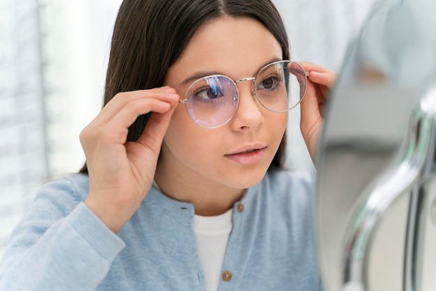 Girl in store trying on glasses