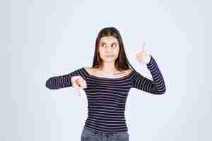 Free photo girl in striped shirt doing enjoyment sign.