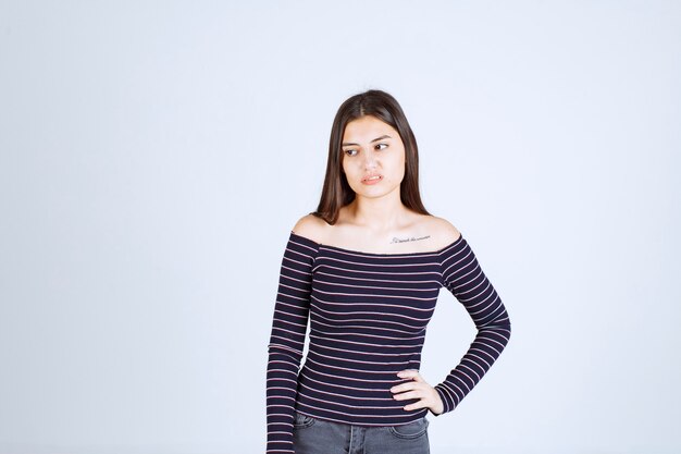 Girl in striped shirt giving neutral poses without reactions. 