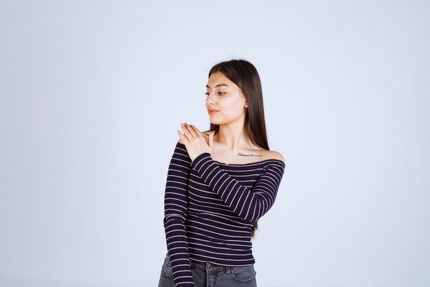 Girl in striped shirt giving neutral poses without reactions.