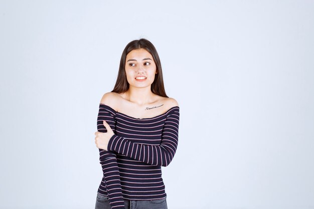 Girl in striped shirt looks terrified and scared. 