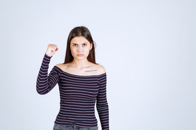 Girl in striped shirt looks terrified and scared. 