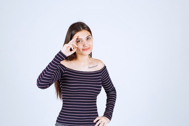 Girl in striped shirt smiling and feeling happy. 