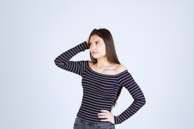 Girl in striped shirt thinking and analizing. 