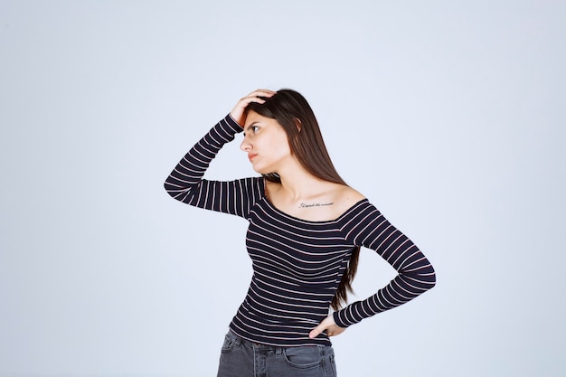 Girl in striped shirt thinking and analizing. 