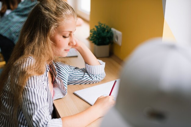 Girl studying in class doing exercises