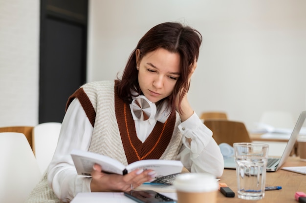 Girl studying from notebook alone during group study