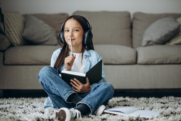 Girl studying at home and listening to music