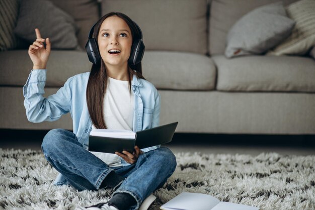 Girl studying at home and listening to music