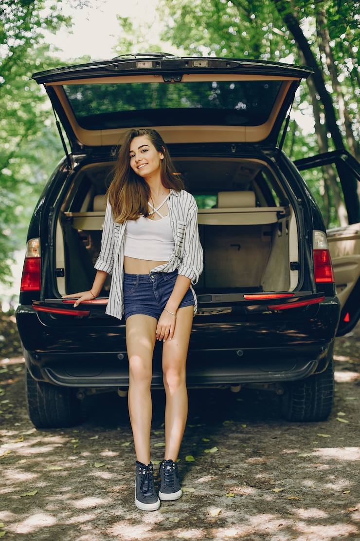 Free Photo girl in a summer park near car
