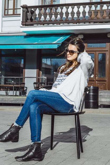 girl in sunglasses in a street cafe