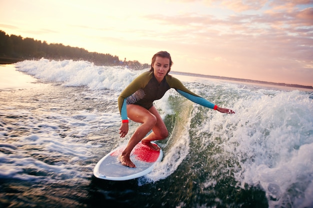 Free photo girl surfing at sunset