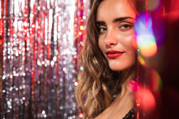 Girl surrounded by blurred curtains of sparkles