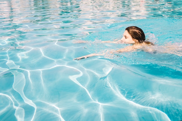 Girl swimming in swimming pool