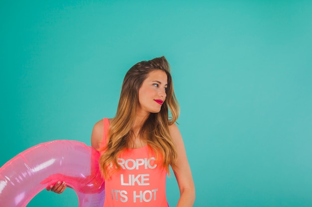 Free photo girl in swimsuit holding inflatable ring