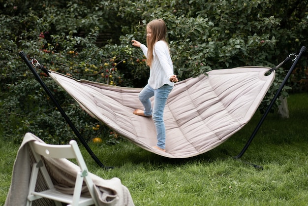 girl swinging standing in a hammock