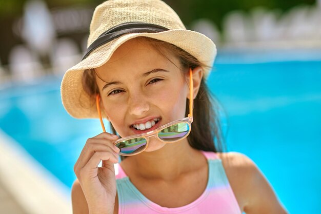 Girl taking off sunglasses looking at camera