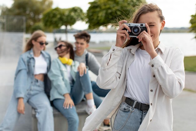 Girl taking a photo next to her friends