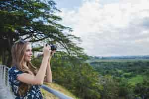 Free photo girl taking photo on viewing platform