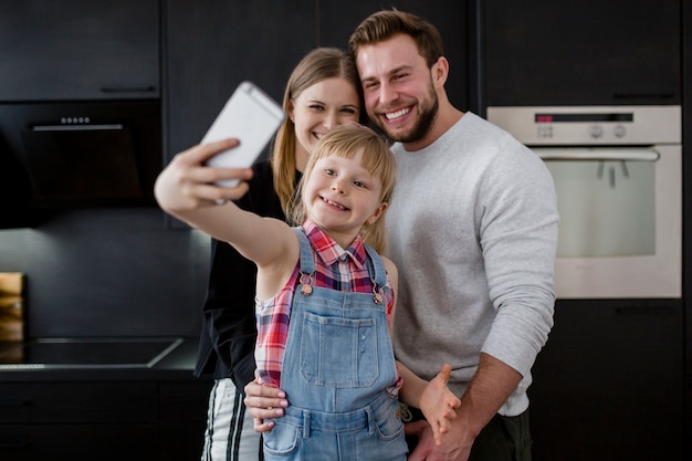 Girl taking picture of family