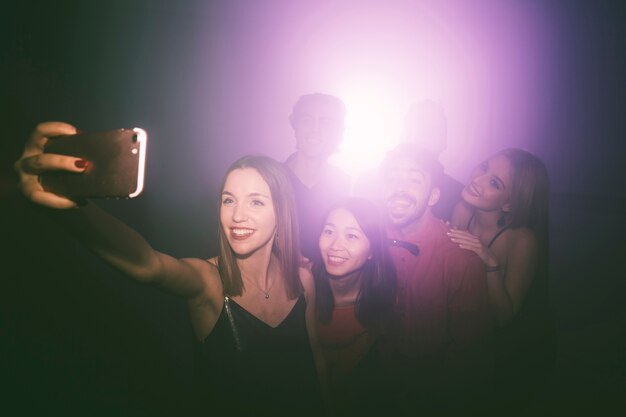 Girl taking selfie in disco