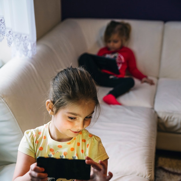 Girl taking selfie on sofa