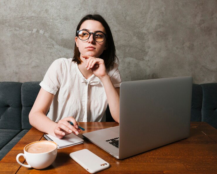 Free Photo girl thinking in front of laptop 