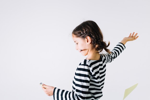 Girl throwing pages from notebook