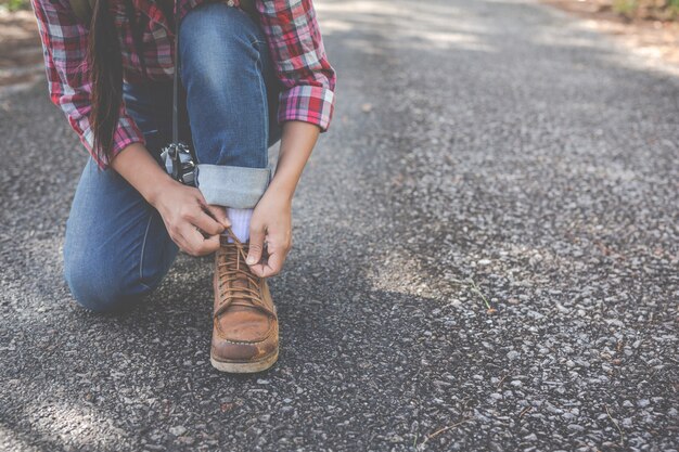 Girl tied rope, traveling shoes, climbing.