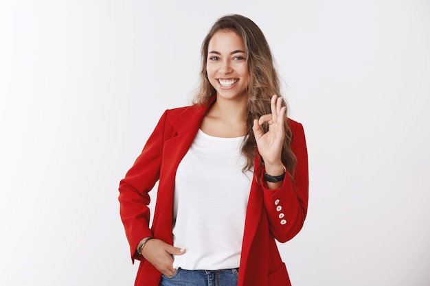 Girl totally confident assured deal already her hands, showing okay ok gesture smiling lucky self-assured holding hand pocket. Successful businesswoman happy everything alright
