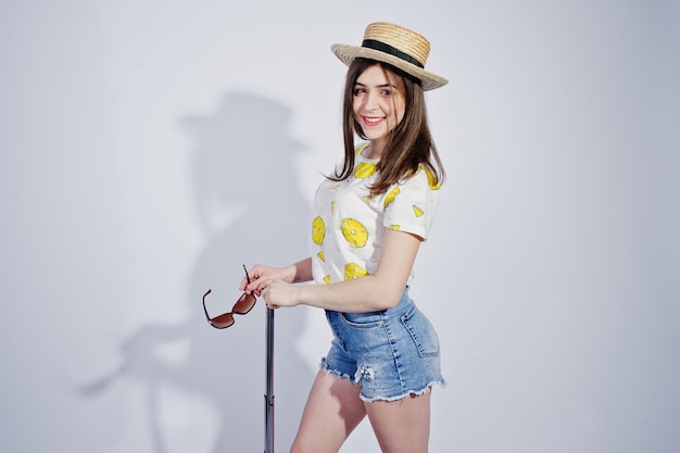 Girl tourist with bag wear in shirt shorts and hat with glasses isolated on white