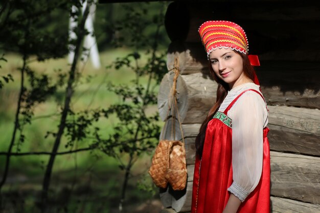 Girl in traditional dress wooden wall