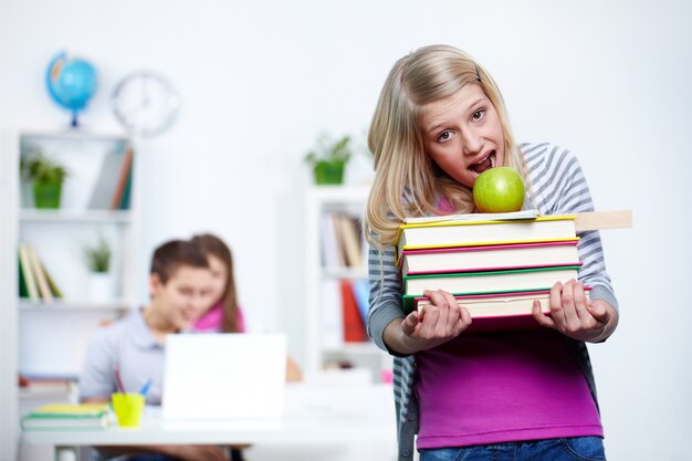 Girl trying to bite an apple