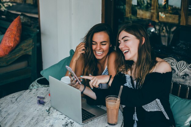 girl using laptop in cafe