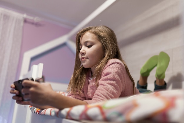 Girl using smartphone on bed