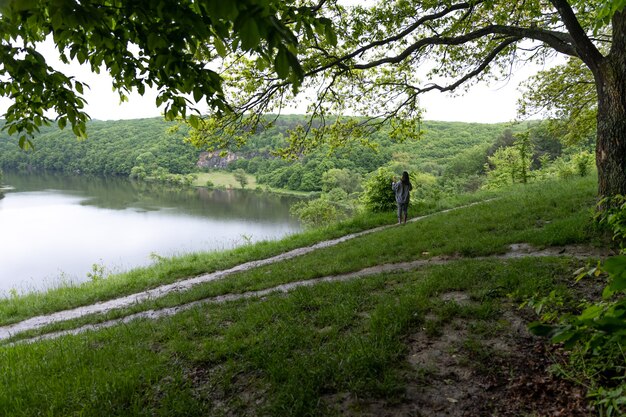 Girl on a walk in the spring forest in cloudy weather.