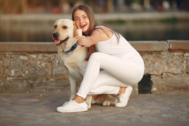 Girl walking in a spring city with cute dog