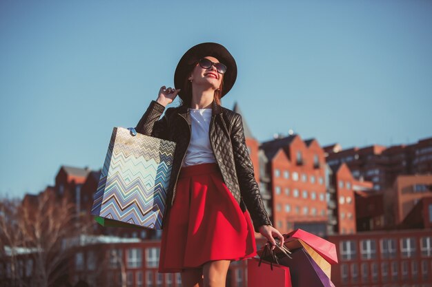 The girl walking with shopping on city streets