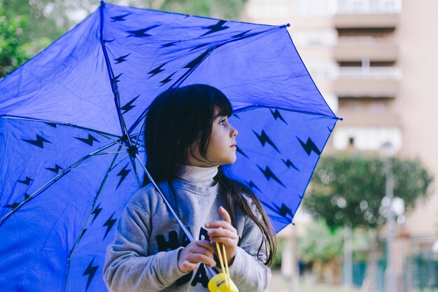 Girl walking with umbrella