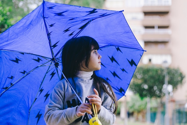 Girl walking with umbrella