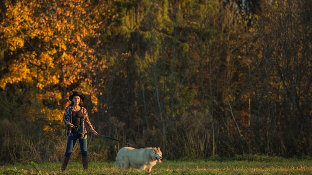 girl walks with husky